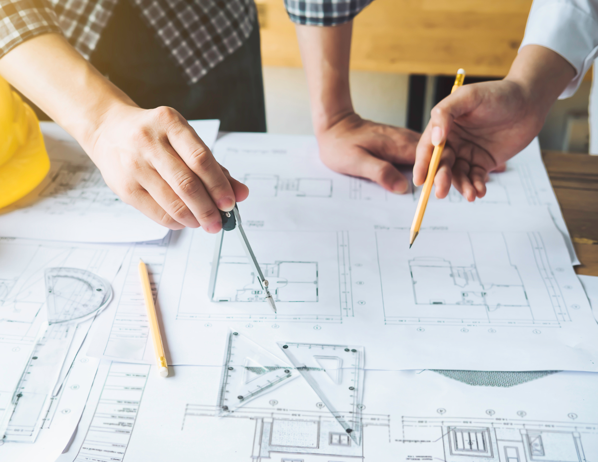 Septic system designers reviewing site plans and blueprints